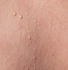 A person's back is wet with water