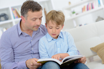 dad and his son reading a book