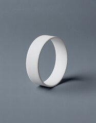 White Badminton Wristband Mockup with Intricate Swirl and Dot Pattern Displayed Against a Neutral Gray Background With Soft Balanced Lighting Creating Subtle Shadows Emphasizing