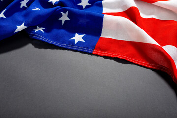 High angle shot of america flag with stars and stripes pattern on black table and copy space