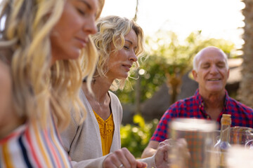 Caucasian mother and father with daughter praying at the garden
