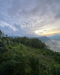 Morning landscape of Pinggan Village Bali with lush green forest and soft sunrise sky, mountain valley scenery