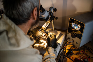 Precision Welding Technician Working in a Workshop With Advanced Equipment in Low Light