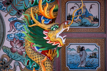 Fototapeta premium Image of displays an ornate dragon sculpture on pillar within a Chinese shrine. Dragon is facing to the right.