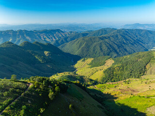 Scenic aerial view of the floating sky road in Nan Province, Thailand, showcasing dramatic mountain layers, winding curves, and a unique highland travel route.