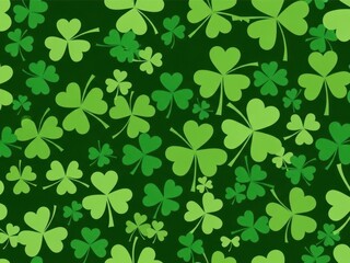 Green shamrock pattern with various sized clover leaves on dark green background