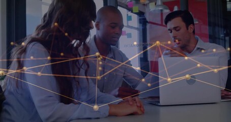 Animation of network of connections over diverse business people using laptop in office - Powered by Adobe