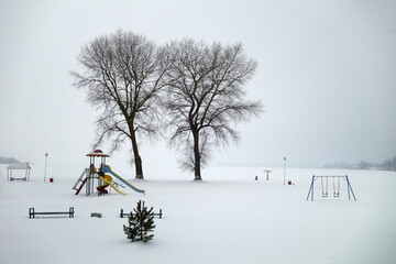 Children playground covered with snow.