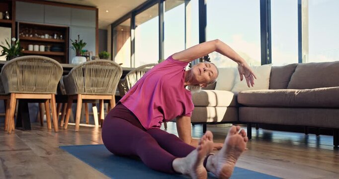 Woman, stretching and fitness on mat, home and workout routine in living room, warm up and wellness. Healthy, mature person and exercise preparation on floor, balance and flexibility for pilates