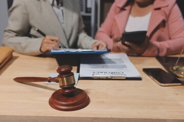 Consultation and conference of professional businesswoman and Male lawyers working and discussion having at law firm in office. Concepts of law, Judge gavel with scales of justice