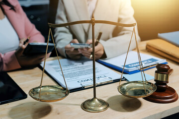 Consultation and conference of professional businesswoman and Male lawyers working and discussion having at law firm in office. Concepts of law, Judge gavel with scales of justice