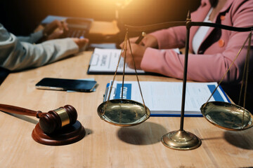 Consultation and conference of professional businesswoman and Male lawyers working and discussion having at law firm in office. Concepts of law, Judge gavel with scales of justice