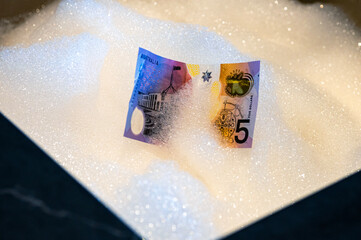 Paper Banknote Lying in Foamy Sink &mdash; Money Laundering Concept