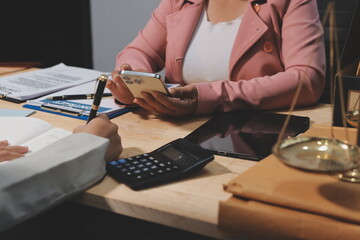 Consultation and conference of professional businesswoman and Male lawyers working and discussion having at law firm in office. Concepts of law, Judge gavel with scales of justice
