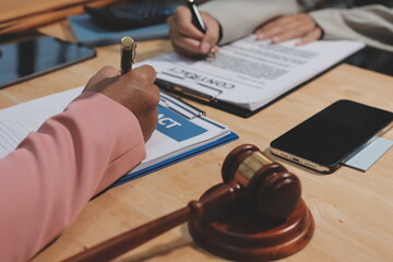 Consultation and conference of professional businesswoman and Male lawyers working and discussion having at law firm in office. Concepts of law, Judge gavel with scales of justice