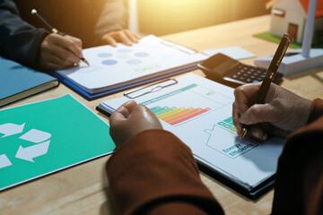 Asian woman lead young group of multiethnic businesspeople in team meeting, using laptop computer for ESG topic presentation on monitor. Sustainable business practice, people work at home concept