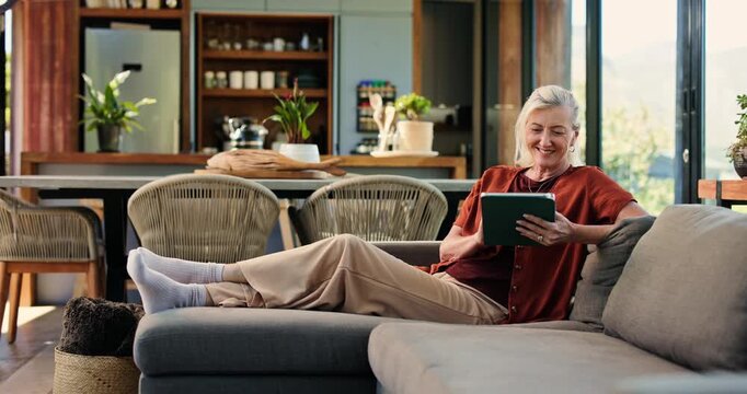 Senior woman, tablet and happy on sofa, scroll and search with movie choice in living room at house. Elderly person, tech and smile on couch with application, subscription or relax in retirement home