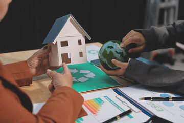 Asian woman lead young group of multiethnic businesspeople in team meeting, using laptop computer for ESG topic presentation on monitor. Sustainable business practice, people work at home concept