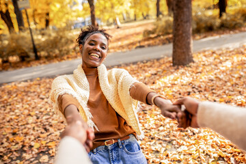 Couple Spinning Hand in Hand in Autumn Park