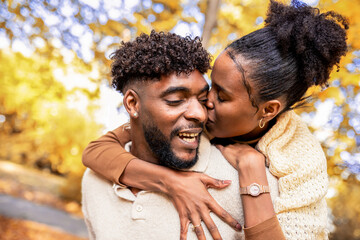 Loving  Couple Sharing Kiss During Piggyback Ride