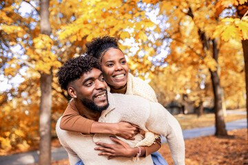  Couple Sharing Loving Autumn Piggyback Moment