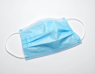 Single blue face covering with ear loops, isolated on white