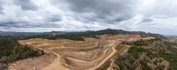 Naklejka premium Aerial view of the Salt del Llop quarry in Sagunto showing the environmental impact of open-pit mining