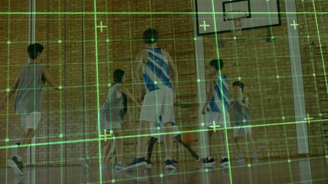 Gray-uniformed boy securing ball top key and driving under hoop with sports grid overlay to score - Powered by Adobe