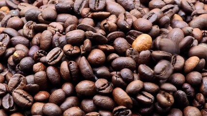 Aromatic roasted coffee beans falling in cinematic slow motion