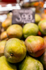 
Fresh organic mangoes for sale at a local city market with price tag