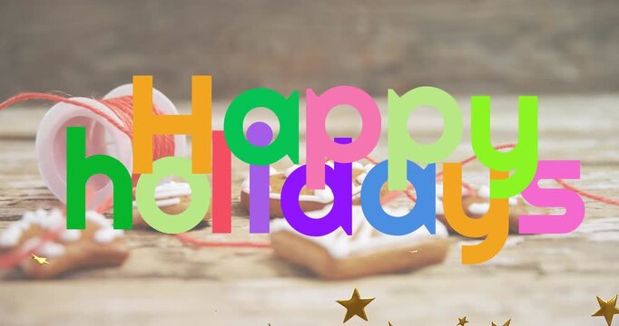 Animation of golden stars and happy holidays text banner against christmas cookies and thread