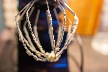 a kitchen food processor after whipping the cake cream. a whisk in the pastry cream.