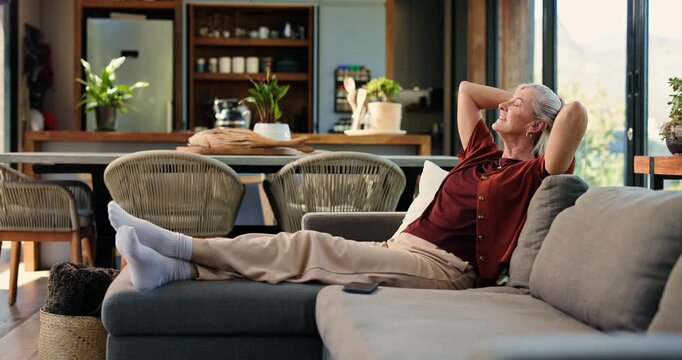 Relax, happy and senior woman on sofa in home for chilling, comfortable and enjoy calm on Sunday afternoon. Retirement, morning and mature person on couch for resting, lazy and peace in living room
