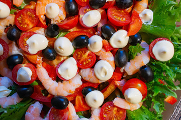 shrimp, olive, and seafood salad in close-up. space for text.