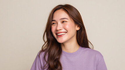 Fototapeta premium Portrait of a Happy Asian Woman Laughing with Long Brown Hair, Isolated on Beige Background