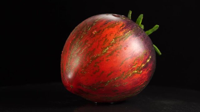 Original heirloom tomato. Rotating on a dark background.