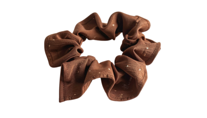 Close-up of a brown, fabric hair scrunchie with tiny speckles
