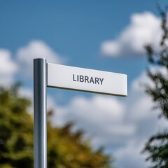 White library sign under a blue slightly cloudy sky in an outdoor setting