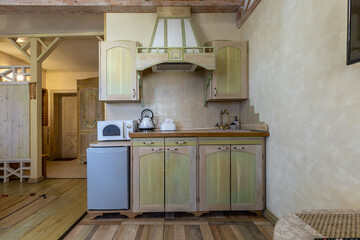 Country style kitchenette with olive wooden cabinets and appliances