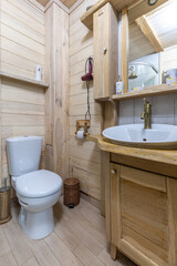 Rustic bathroom interior with wooden vanity and natural timber walls