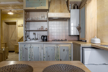Rustic kitchen interior with hand-painted wooden cabinets