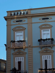 Traditional residential building in Valencia painted in pastel blue and beige, with balconies and classic architectural details.