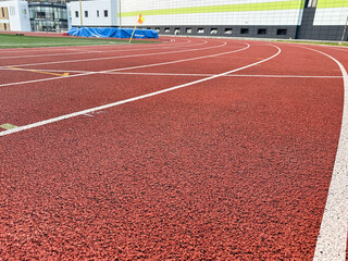 Red running track with clearly marked white lanes.