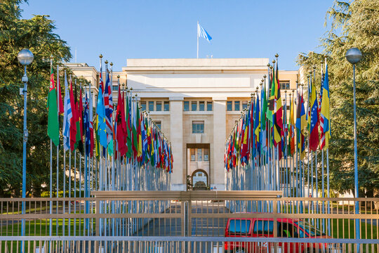 The row of every country flag at the main entrance into United Nations Offices or Palais des Nations with closed gate illustrating lockdown. Geneva, Switzerland