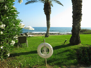 Beautiful landskape, palm trees and sun loungers at luxury resort
