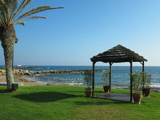 Beautiful landskape, palm trees and sun loungers at luxury resort