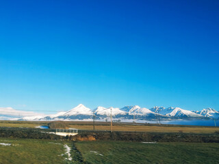 Winter landscape with snow-capped Tatra mountains on horizon in Slovakia