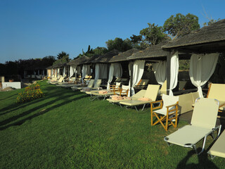 Beautiful landskape, palm trees and sun loungers at luxury resort