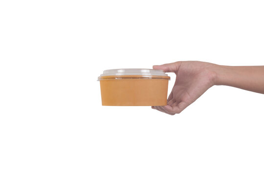 Hand hold Round brown cardboard food container isolated on white background.