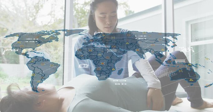 Physiotherapist assessing patient's knee range while world map overlay appearing with data nodes